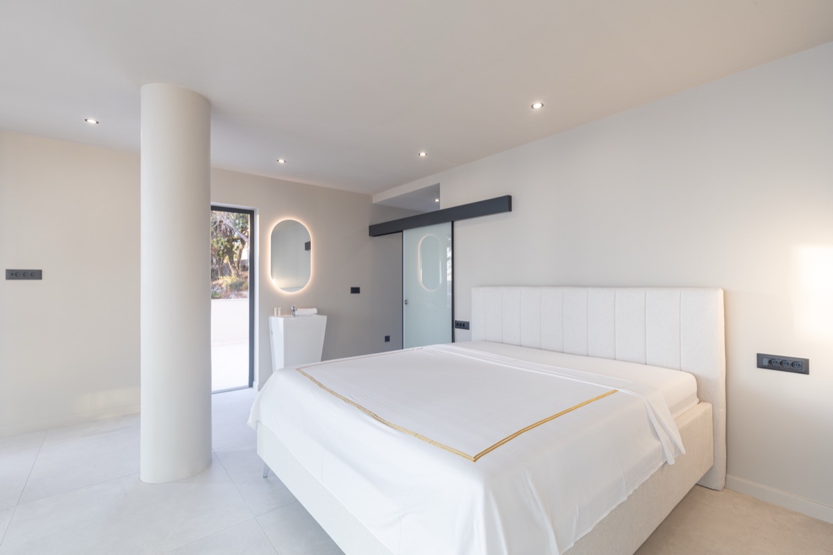 Bedroom with backlit mirror
